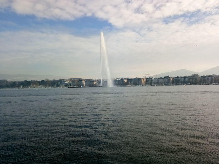 Scenic view of sea and city against sky