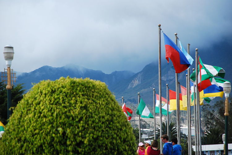 Panoramic view of flag on mountain against sky