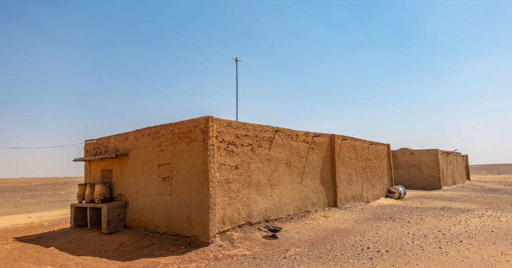 Built structure on desert against clear sky