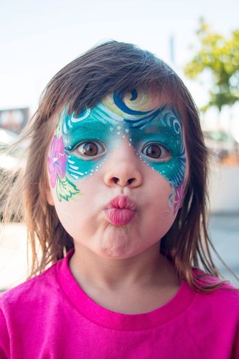 Close-up portrait of girl with face paint