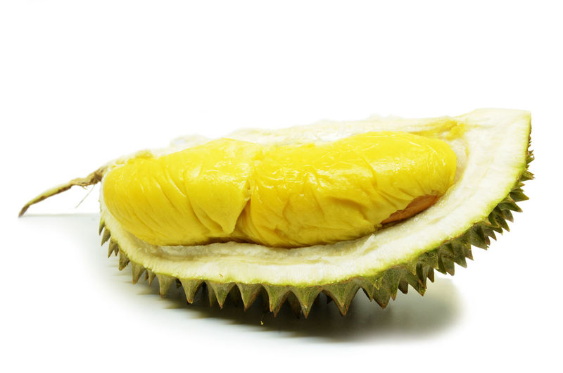 Close-up of lemon slice over white background