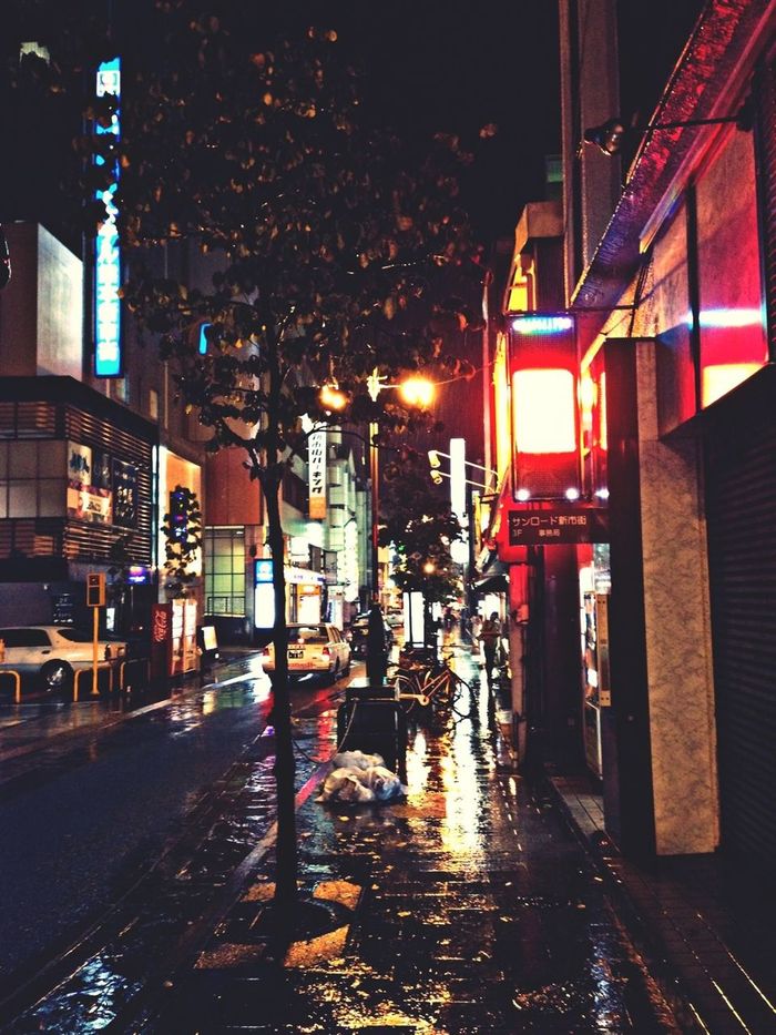 VIEW OF ILLUMINATED STREET AT NIGHT