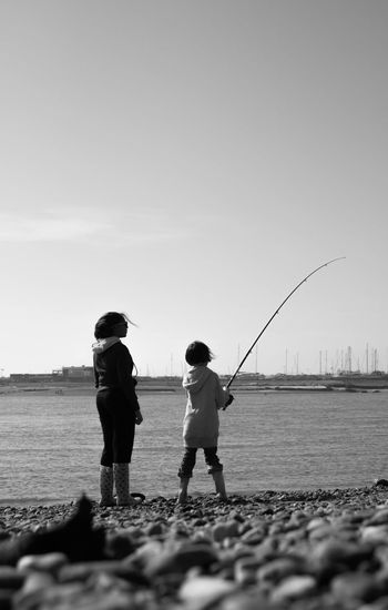 Full length of child fishing