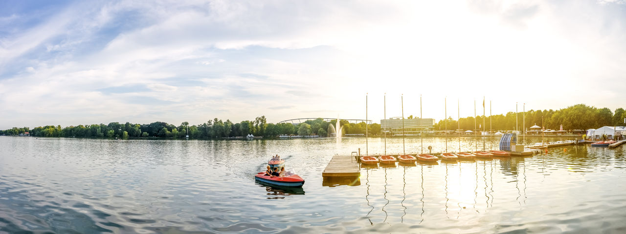 Boats in river against sky