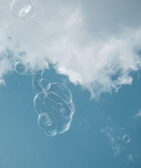 Low angle view of bubbles in sea against sky