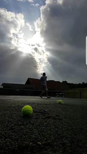 Man playing with ball against sky