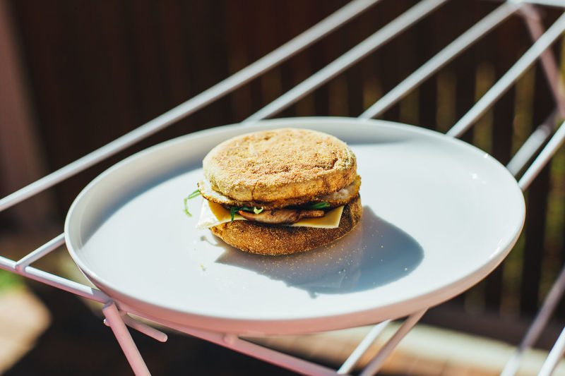Close-up of burger in plate on clothes rack