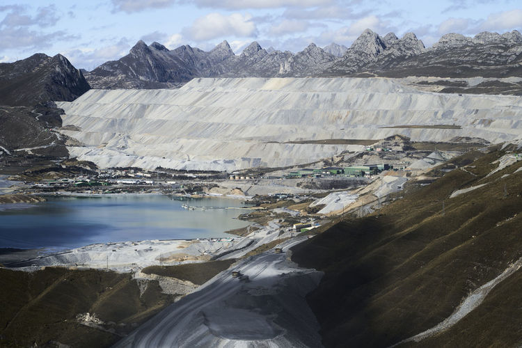 Mine in the high country of the andes, terraces of excavation and commercial mining equipment