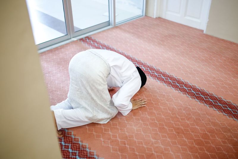 High angle view of man praying in room