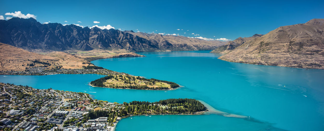 Panoramic view of lake and mountains against blue sky