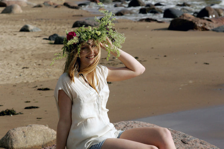 Woman wearing flowers at beach