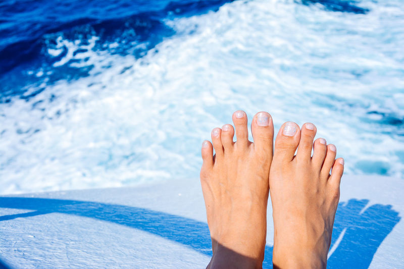 Low section of woman relaxing on beach