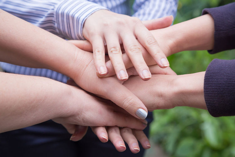 Cropped image of hands gathered in unity