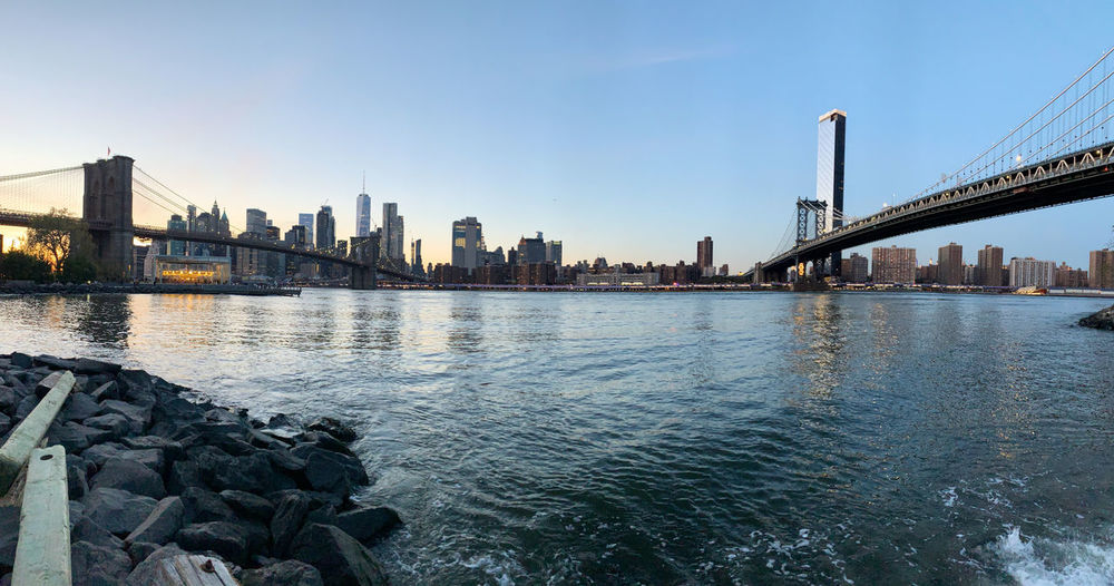 Suspension manhattan bridge over river in new york city against sky