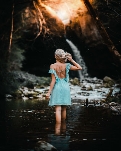 Rear view of woman standing in water