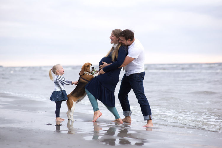 Full length of happy family at beach