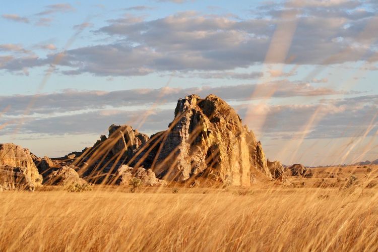 Panoramic view of rock formations on land against sky