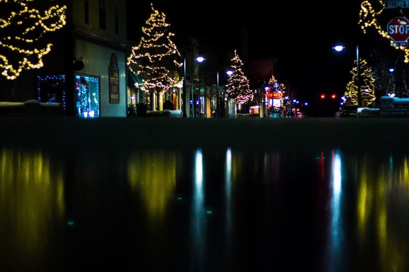 Illuminated christmas lights in city at night