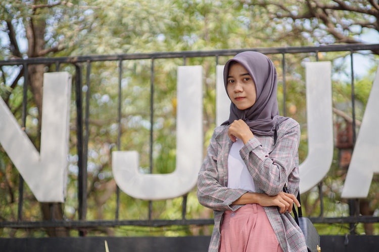 Muslim hijab student in front of the park
