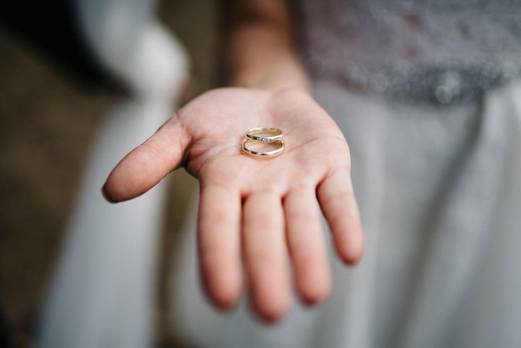 Midsection of bride holding wedding rings