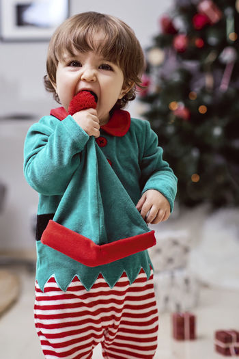 Cute boy holding christmas tree