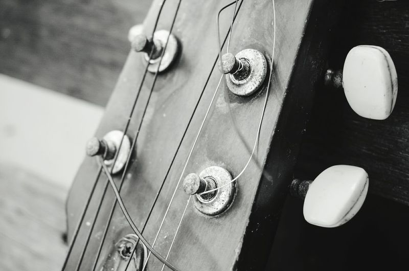 Close-up of guitar headstock on table
