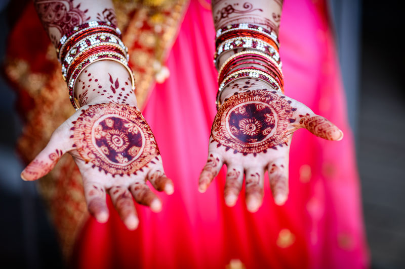 Close-up of bride with henna tattoo during wedding ceremony