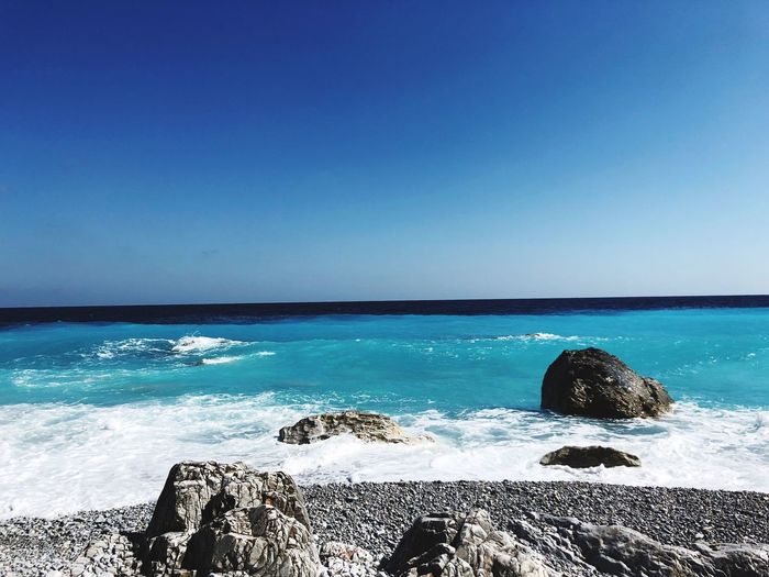 Scenic view of sea against clear blue sky