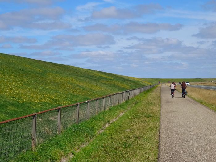 Bicycling on country road along landscape