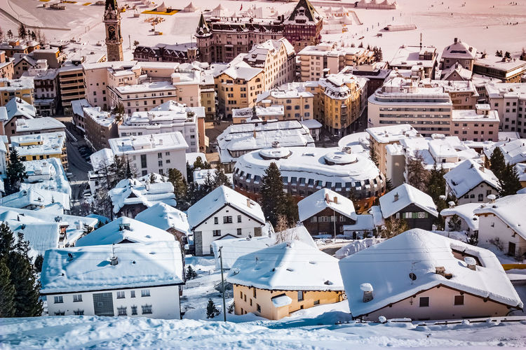 High angle view of snow covered houses in city