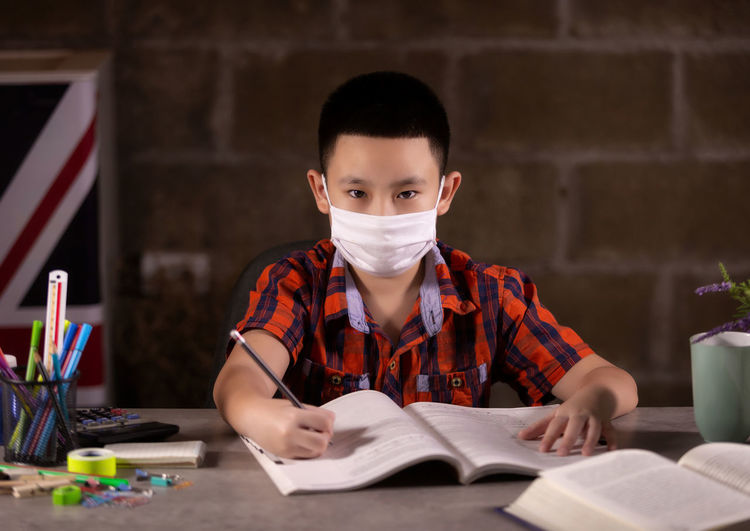 Portrait of boy reading book