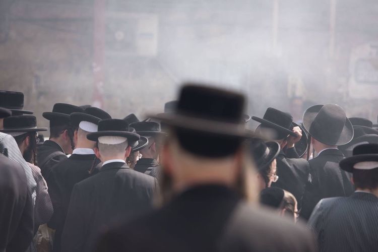 Rear view of men in traditional clothing during celebration