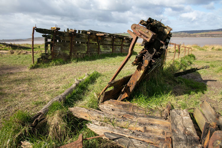 Abandoned truck on field against sky