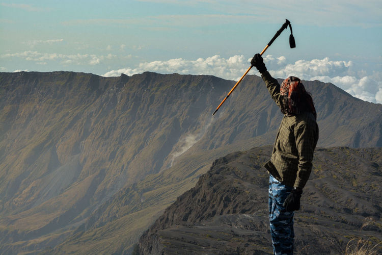 Expression of victory in front of the giant caldera of mount tambora