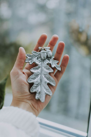 Cropped woman holding christmas decoration