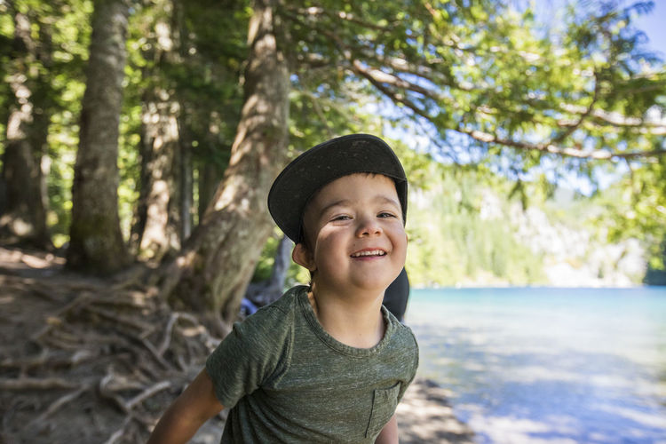 Portrait of happy four year old boy at lindeman lake, chilliwack, b.c.