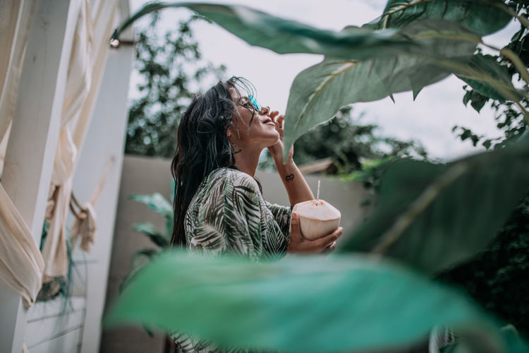 Midsection of woman sitting outdoors