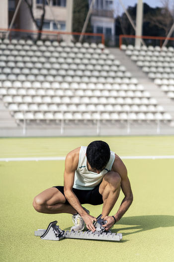 Male athlete sitting outdoors