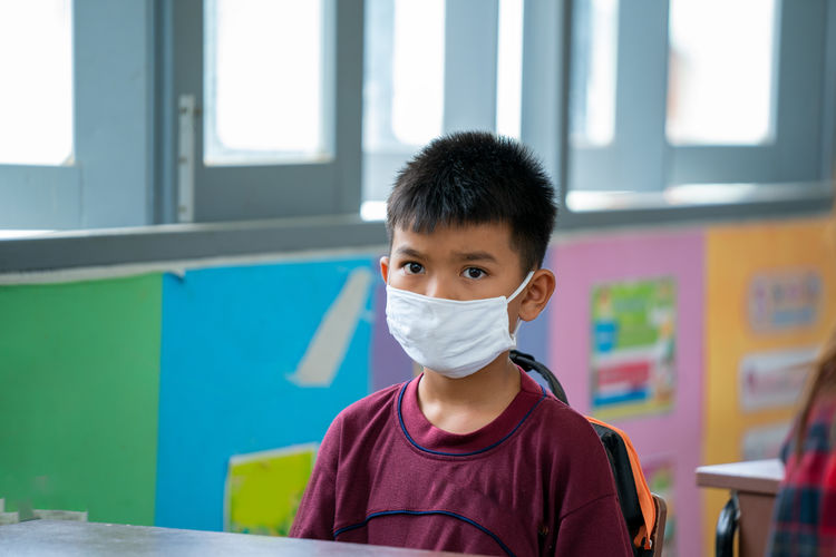 Portrait of an elementary school wearing protective mask to prot