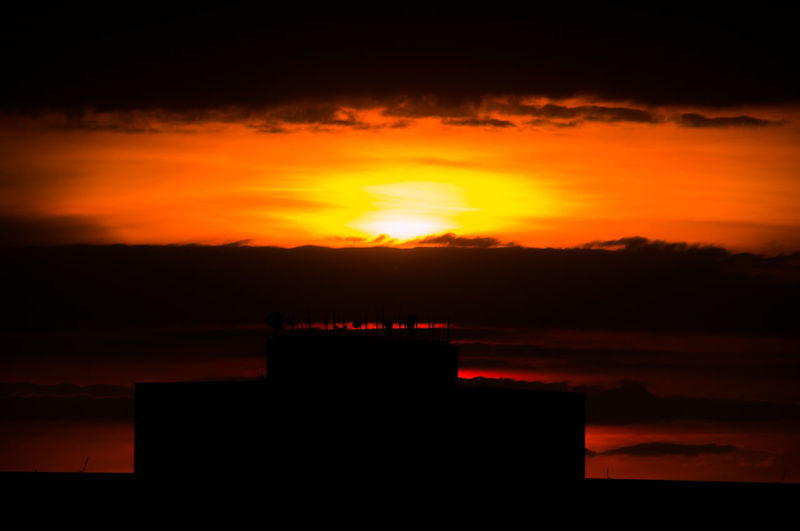 Silhouette building against sky during sunset