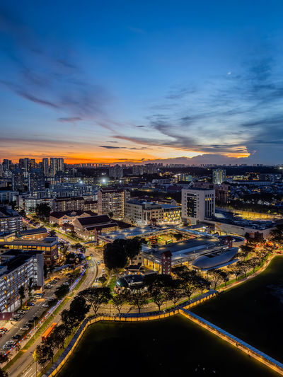 High angle view of illuminated cityscape against sky during sunset