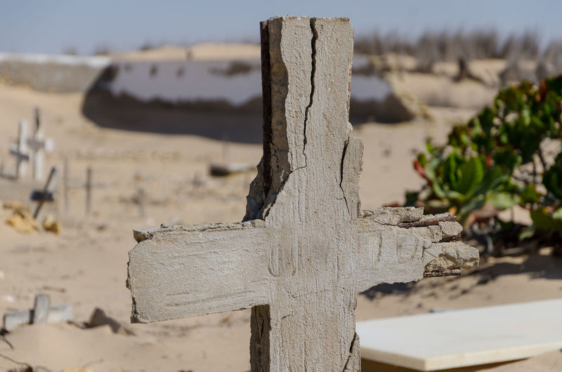 Close-up of crumbling cross at graveyard in namib desert, angola, africa
