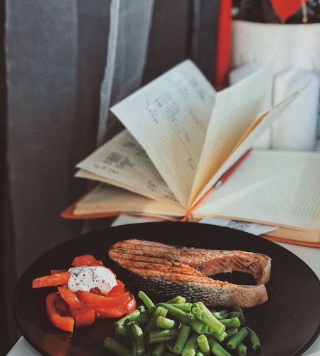 Food served in plate with books on table