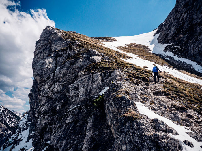 Low angle view of person on snow covered mountain