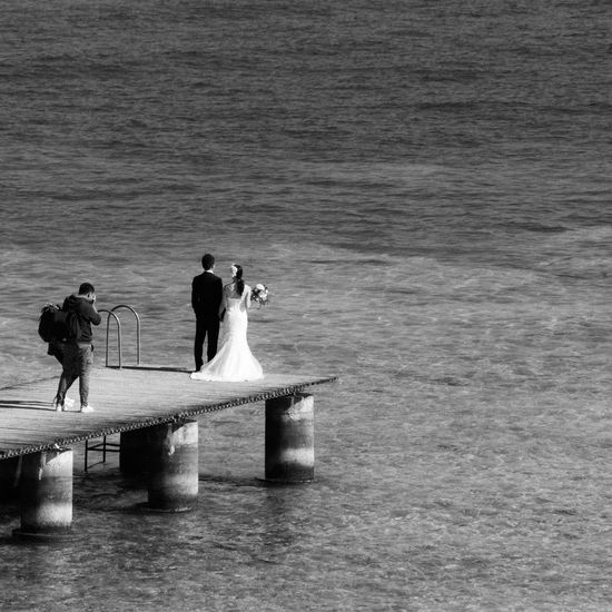 People on pier over lake