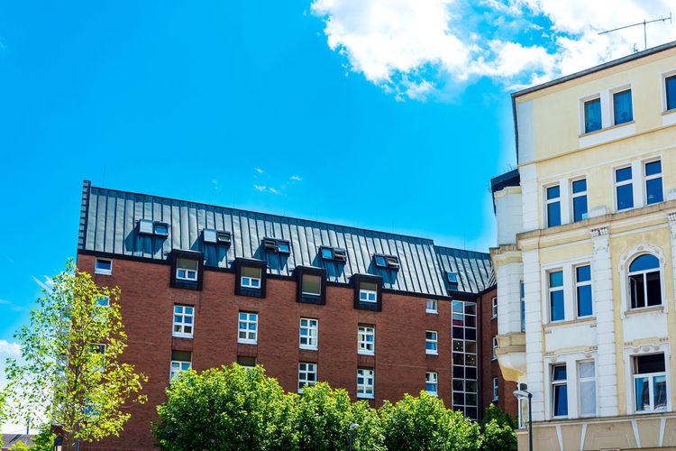 Low angle view of buildings against clear blue sky