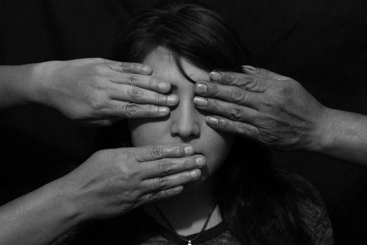 Close-up of a hands on woman's face