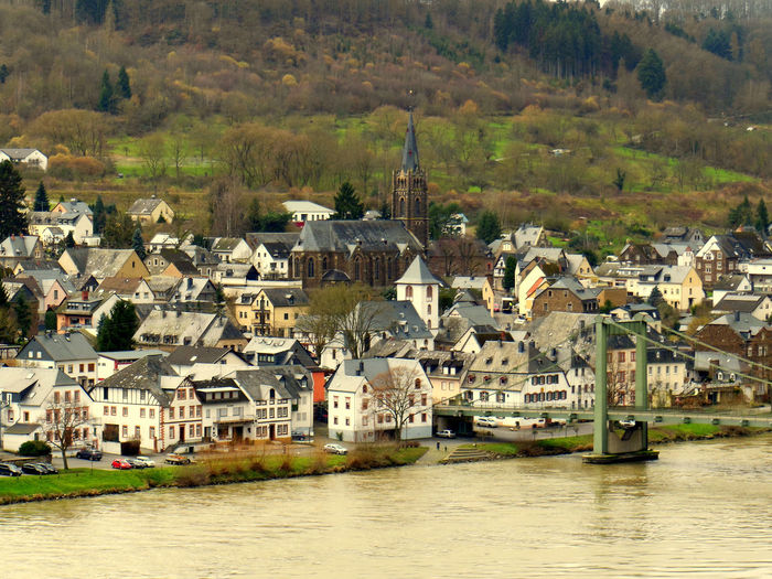 Houses by river in town