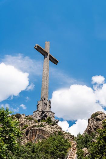 Low angle view of cross against blue sky