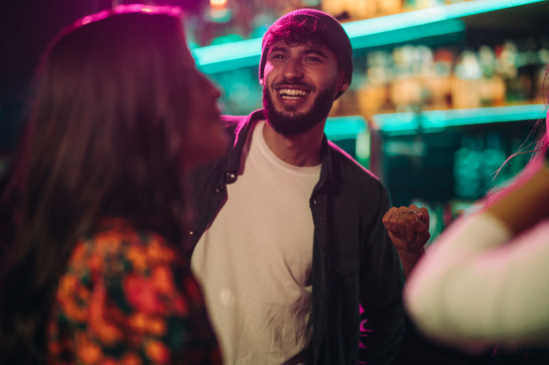 Smiling young man enjoying at bar